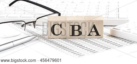 Cba Written On Wooden Cube With Keyboard , Calculator, Chart,glasses.business Concept