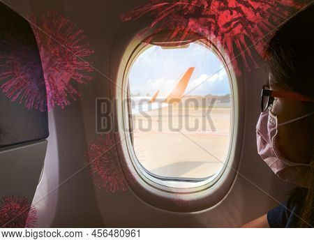 Woman Wear Surgical Mask Sit On Passenger Seat Near Cabin Window Of The Airplane And Monkeypox Virus