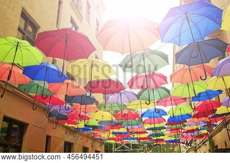 Colored Umbrellas Hanging At Top. Set Of Different Umbrellas. Local Landmark. Cafe Decoration In Lod