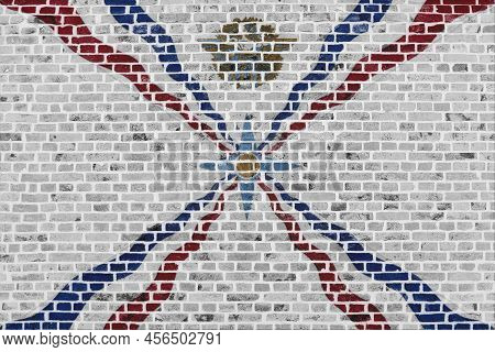 Close-up On A Brick Wall With The Flag Of Assyria Painted On It.