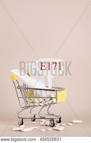Titanium Dioxide, E171, Dangerous Additive Concept. Gum, Pills, Toothpaste, Cream In Basket And Sign