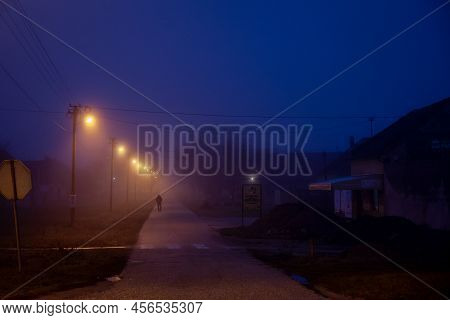 Vladimirovac, Serbia - December 26, 2021: Selective Blur On A Man Walking Alone Disappearing And Fad