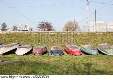 Row Of Boats And Ships, Some Fishing Ships And Old Boats Standing Upside Down, Being Repaired, On Th