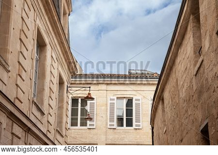 Facade Of A Typical Old French Residential Building In Bordeaux, France, Made Of Freestone, Hosting 