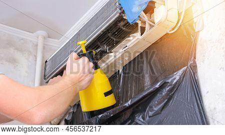 A Man Washes Off A Special Foam For Cleaning Air Conditioners With A Jet Of Water Under Pressure. Sp