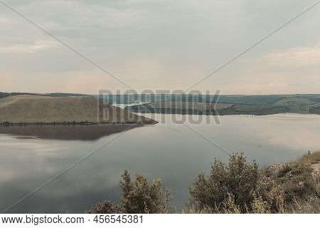 The Banks Of A Large River With Smooth Calm Water. The Panoramic Landscape. Bakota, Dniester River, 