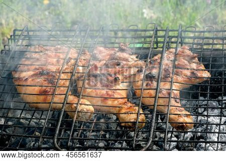 Cooking Outside As Picnic Time With Barbecue Grid. Grilled Chicken Meat. Chiken Legs On Grill Grid. 