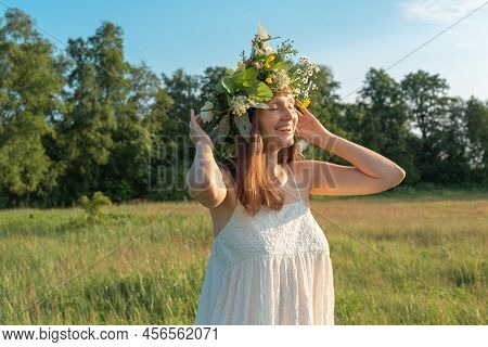 Beautiful Brunette Woman In Flower Wreath. Summer Solstice Day. Midsummer.