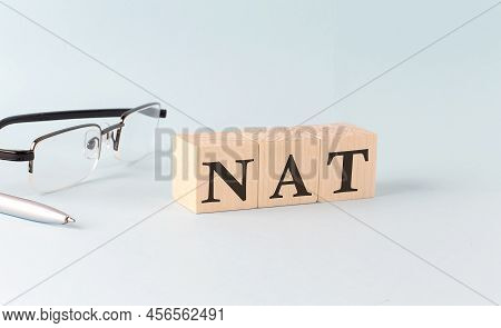 Text Nat Network Address Translation - Written On The Wooden Cubes On A Blue Background