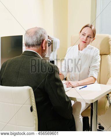 Ophthalmologist Examination Of Elderly Man On Corneo Topographer.modern Clinic