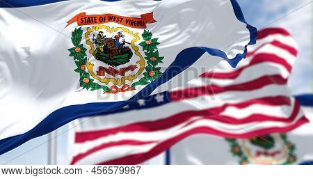 The West Virginia State Flag Waving Along With The National Flag Of The United States Of America. We