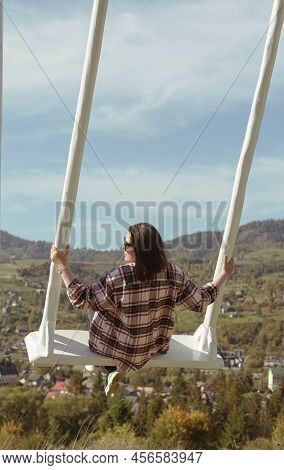 Woman On White Wooden Swing On Mountain View