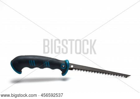 Close Up Of Small Pointed Hand Saw With Sharp Pointed Short Blade And Clearly Visible Teeth On White