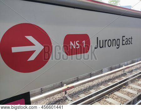 Singapore- Apr 3, 2022:  Red Arrow Shows The Direction Toward Jurong East Statioin At Mrt Platform. 
