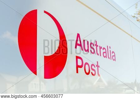 Sydney, Australia 2022-05-08 Australia Post White Truck Van With Logo And Street Houses Reflection.