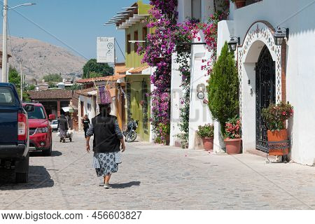 Teotitlan Del Valle, Oaxaca, Mexico- May 23, 2022: Woman Walking At The Street, And Carrying A Bag I