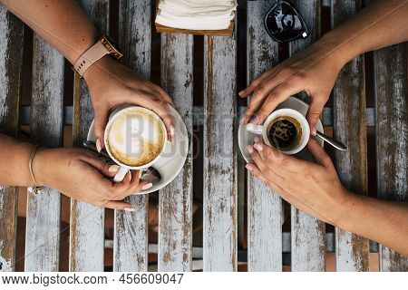 Close Up Vertical View Of Couple Of Females Caucasian Friends Having A Coffee And Cappuccino Break T