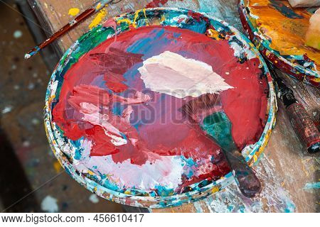 Bright Spots Of Paint In An Art Workshop With A Brush