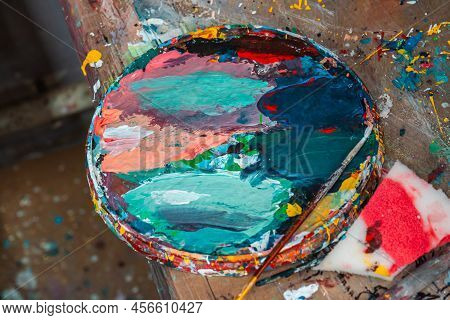 Bright Spots Of Paint In An Art Workshop With A Brush