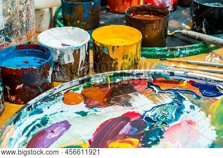 Jars Of Bright Colors And Brushes In An Art Workshop