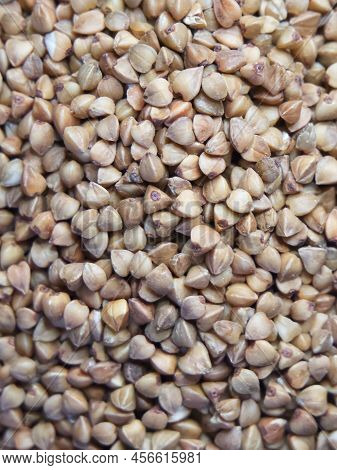 Organic Buckwheat Groats Macro Background. Roasted Dry Buckwheat Grains Texture Close-up. Wholegrain