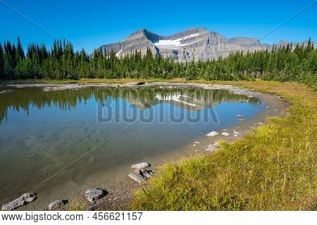Piegan Mountain And Piegan Glacier Reflecting In Lake Surface. Glacier National Park, Montana, Usa, 