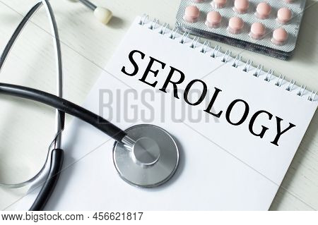 Serology Text On A Notepad On A Table Next To A Tablet With A Stethoscope On The Table