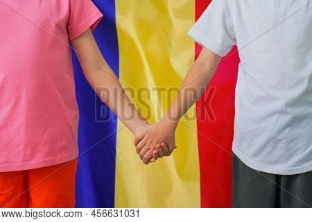 Two Children Joined Hands On Flag Moldavia Background. Boy And Girl Joined Hands On Background Flag 