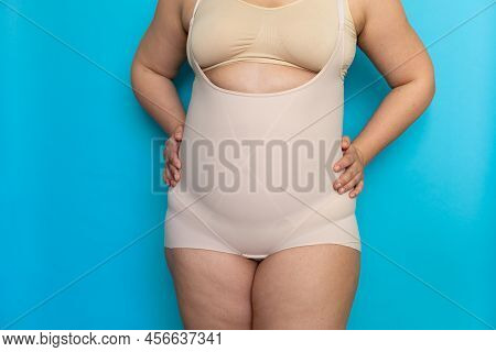 Plus Size Woman With Cellulite Hips In Beige Shapewear Panties On Belly Closeup. Tighten Figure And 