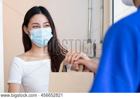 Young Asian Woman, Customer Wearing Face Mask Protect To Pandemic Of Covid And Received Bag,cardboar