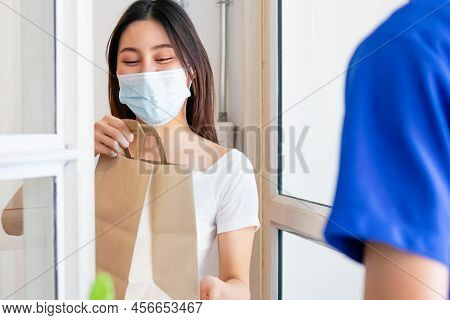 Young Asian Woman, Customer Wearing Face Mask Protect To Pandemic Of Covid And Received Bag,cardboar