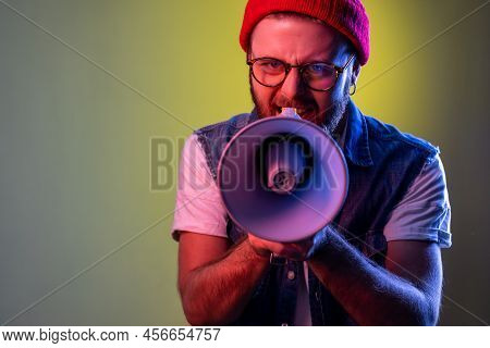 Angry Hipster Man Holding Megaphone Near Mouth Loudly Speaking, Screaming, Making Announcement, Payi