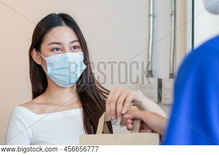 Young Asian Woman, Customer Wearing Face Mask Protect To Pandemic Of Covid And Received Bag,cardboar