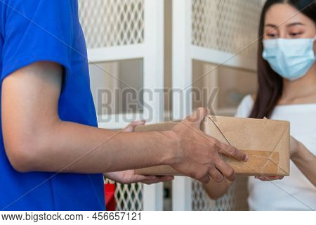 Young Asian Woman, Client Received A Delivery Of Cardboard Box, Parcel From Delivery, Postman, Weari