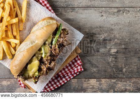 Philly Cheesesteak Sandwich With Beef, Cheese,green Pepers And Caramelized Onion On Wooden Table.tra