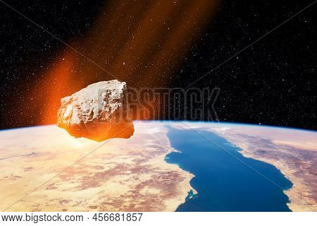 Planet Earth And Big Asteroid In The Space. Potentially Hazardous Asteroids. Asteroid In Outer Space