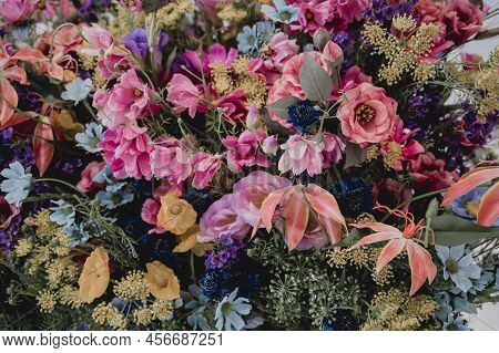 Big Bouquet Of Flowers In A Vase On A Gray Wall Background