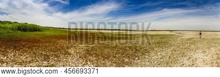 A Panoramic View Of A Dried Lake With Walking Woman On Steppe Near The Sea Of Azov, Ukraine