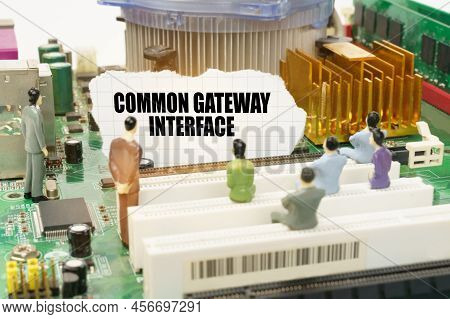 Technology And Computer Concept. On The Motherboard There Are Figures Of People And Torn Paper With 