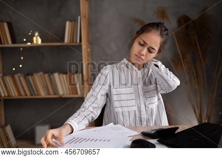 Young Hispanic Woman Suffering From Neck Pain In Home Office
