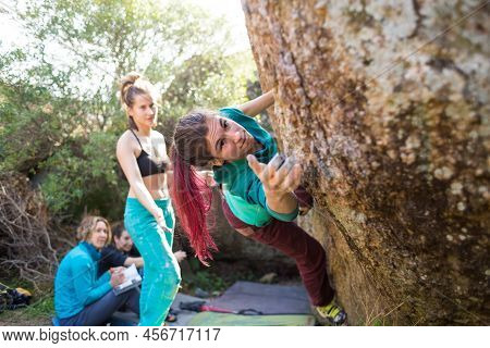 Friends Go In For Sports In Nature, Bouldering On Rocks, Girl Climbs A Big Stone, Woman Is Belayng P