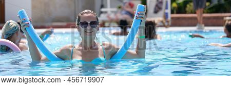 Happy Woman Swims In The Outdoor Summer Pool. Aqua Aerobics, Healthy Recreation At The Resort, Aquaf