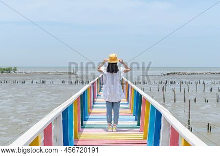 The Back View Of Asian Woman Walking On The Rainbow Bridge To See The Viewpoint At The Samut Sakorn 