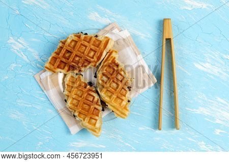 Croffle Or Croisant Waffle Dessert, A Marriage Between A Croissant And A Waffle Iron. Topview. Blue