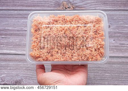 A Box Of Sweet And Sour Crispy Noodles (or Mee Krob In The Thai Language) On A Palm Young Woman With