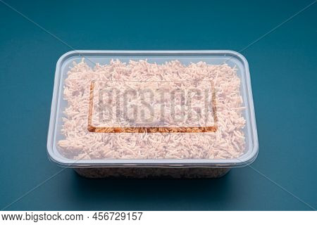 A Box Of Sweet And Sour Crispy Noodles Or Mee Krob In The Thai Language On A Blue Light Background. 