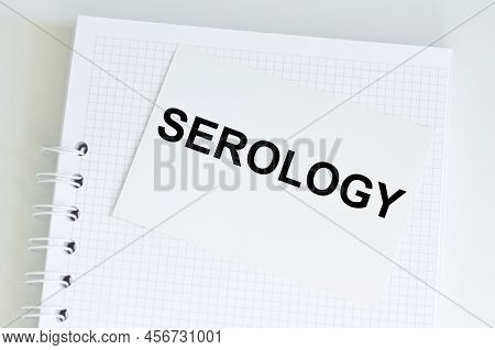 Serology Text Card On A Notebook That Sits On A Light Desk, A Medical Concept