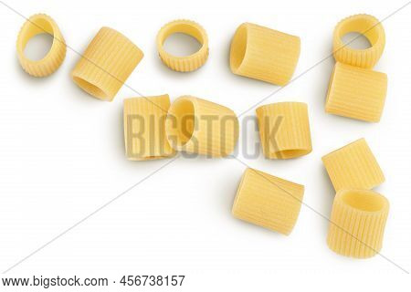 Raw Italian Pasta Isolated On White Background. Mezze Maniche Rigate Bronze Die. Top View With Copy 