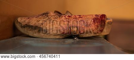 Enkhuizen, Netherlands, June 2022. Old Wooden Shoes On A Bench.
