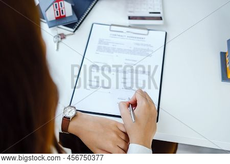 Guarantee, Mortgage, Agreement, Contract, Signing, Male Client Holding Pen To Reading Agreement Docu